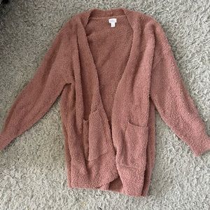 Stars above pink fuzzy cardigan
